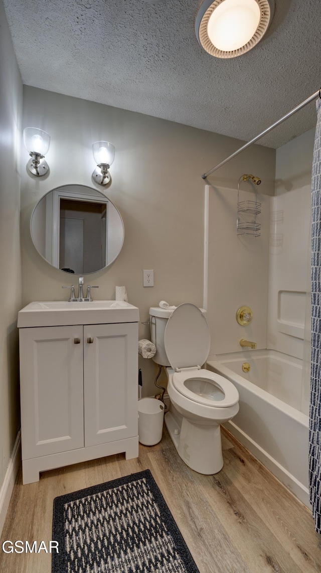 full bath featuring toilet, shower / bath combination, a textured ceiling, and wood finished floors