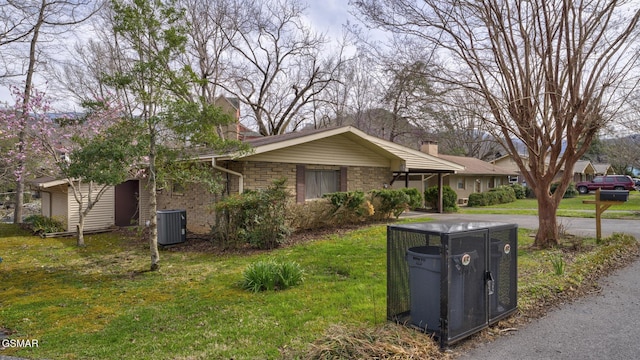 ranch-style house with cooling unit, a chimney, and a front lawn