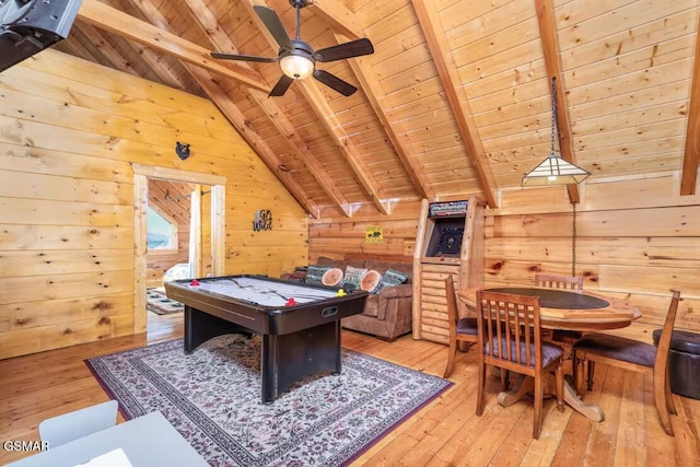 playroom with lofted ceiling with beams, wood walls, wooden ceiling, and light wood-style flooring