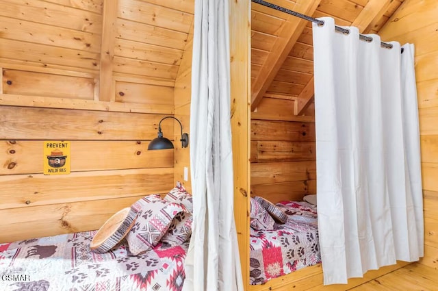 bedroom with wood walls and wooden ceiling