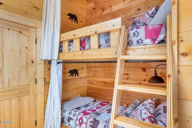 bedroom featuring wood walls