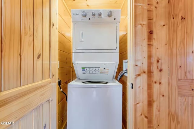 laundry room with stacked washing maching and dryer and laundry area