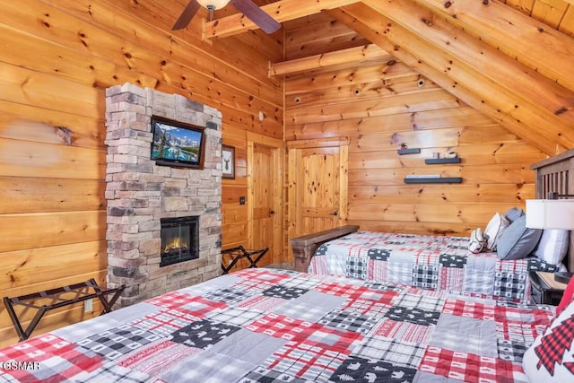 bedroom with wooden walls, vaulted ceiling with beams, and a fireplace