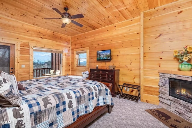 bedroom with a fireplace, wood walls, carpet flooring, and wooden ceiling