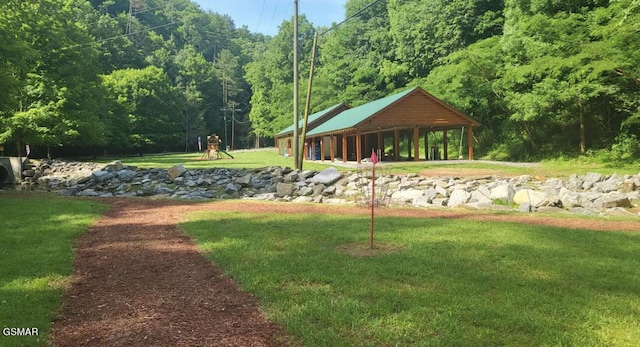 view of home's community featuring a playground and a lawn