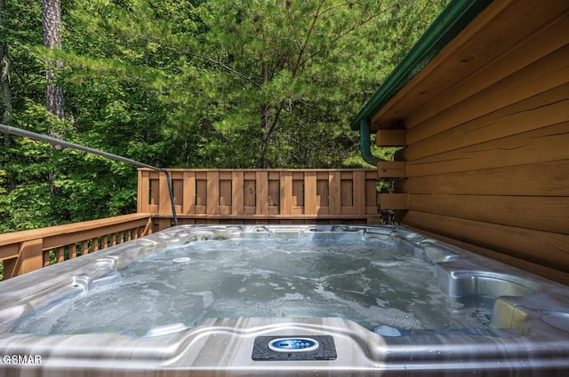 wooden terrace with a hot tub