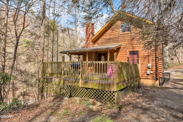 rear view of property with a chimney