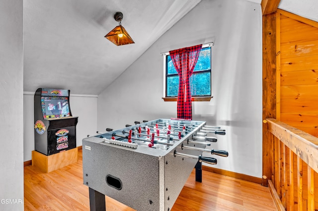 playroom with baseboards, vaulted ceiling, and wood finished floors