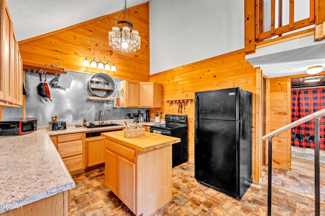 kitchen featuring black appliances, light brown cabinets, wood walls, and a center island