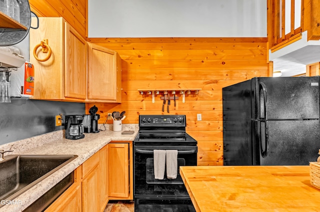 kitchen with open shelves, wooden counters, a sink, wood walls, and black appliances