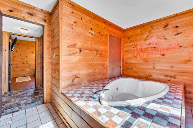 full bathroom featuring tile patterned flooring, wood walls, and a bath