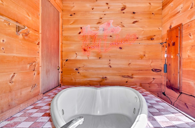 full bathroom with wooden walls and tile patterned floors