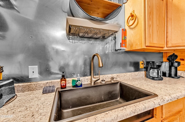 kitchen with light stone countertops and a sink