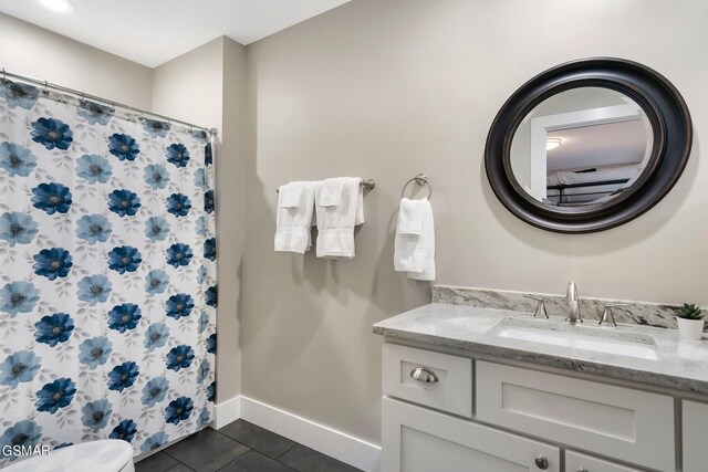 bathroom featuring tile patterned floors, vanity, and toilet