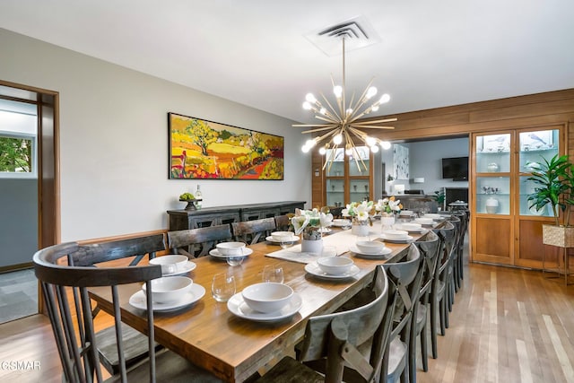 dining room featuring light hardwood / wood-style floors and an inviting chandelier