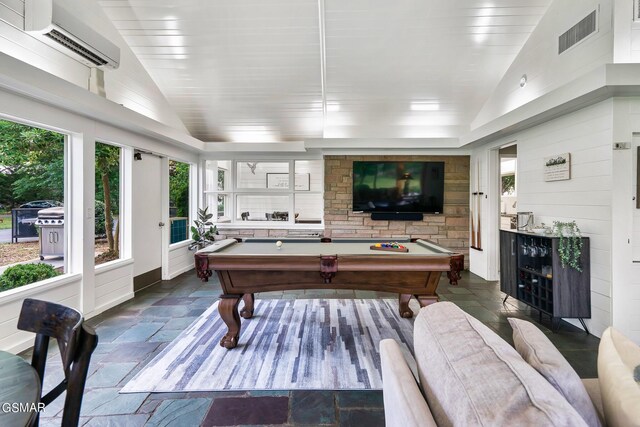 recreation room featuring a wall mounted air conditioner, vaulted ceiling, and billiards