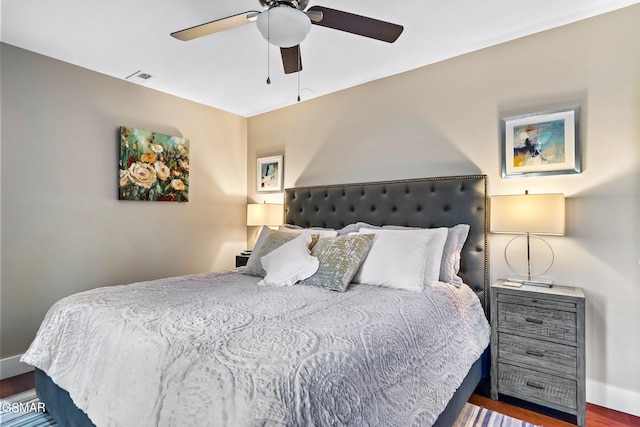 bedroom featuring ceiling fan and dark wood-type flooring