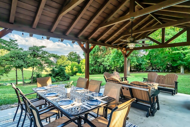 view of patio with ceiling fan and a fire pit