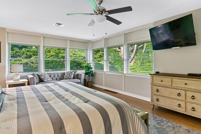 bedroom with ceiling fan and dark hardwood / wood-style floors