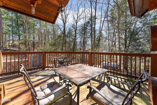 wooden terrace with outdoor dining area