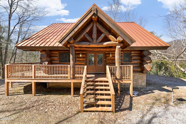 log cabin featuring a standing seam roof, metal roof, french doors, and log siding