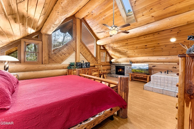 bedroom with wooden ceiling, vaulted ceiling with skylight, log walls, and wood finished floors