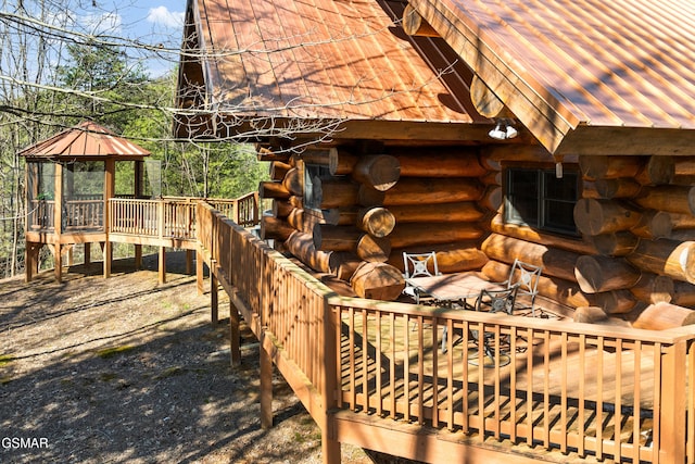 view of home's exterior featuring log siding and a gazebo