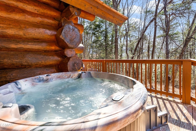 wooden deck with an outdoor hot tub