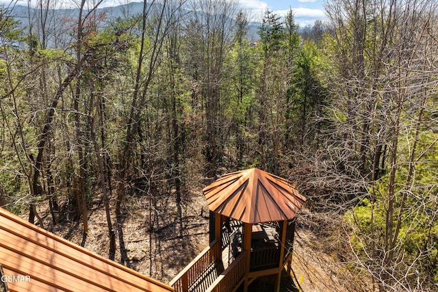 exterior space featuring a forest view