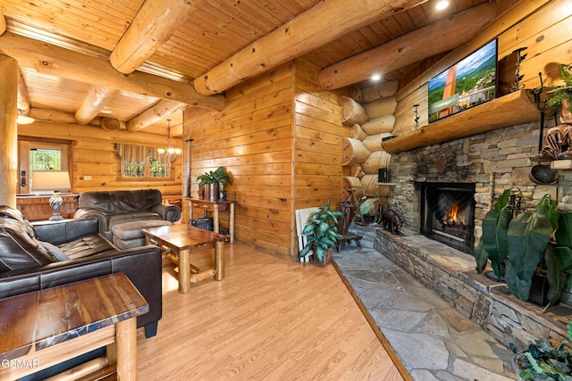 living room featuring a stone fireplace, beam ceiling, wood finished floors, and wood ceiling