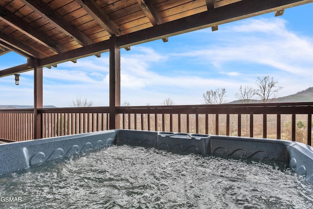 wooden deck with a hot tub