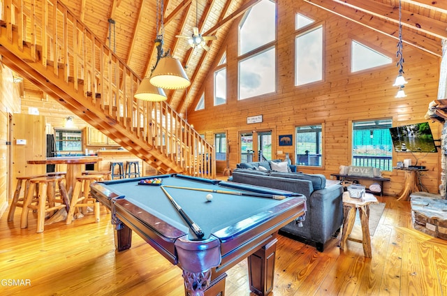 recreation room with hardwood / wood-style floors, wooden walls, pool table, wooden ceiling, and a dry bar