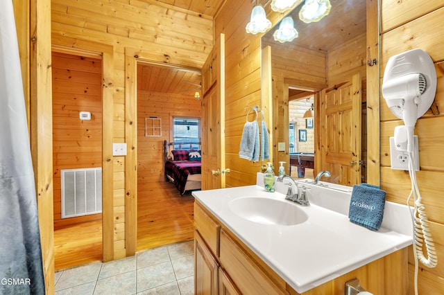 bathroom featuring visible vents, wood ceiling, wood walls, and tile patterned flooring