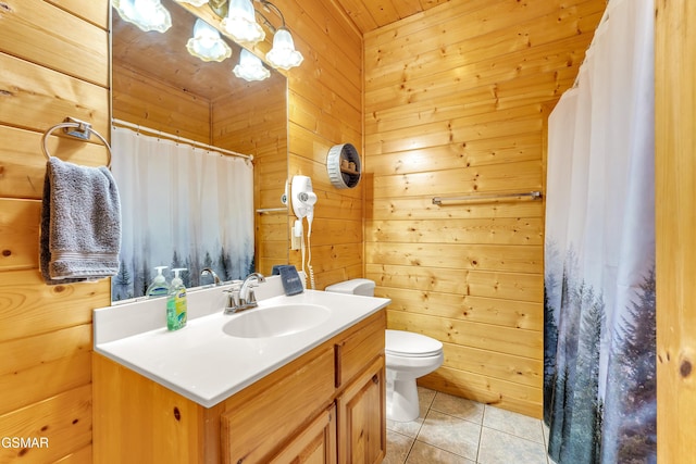 bathroom featuring a shower with curtain, toilet, wood walls, tile patterned flooring, and vanity