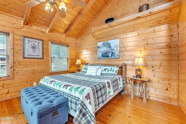 bedroom featuring wood walls, wooden ceiling, vaulted ceiling with beams, and wood finished floors