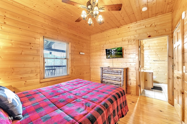 bedroom featuring wood walls, wood ceiling, ensuite bathroom, and light wood-style floors