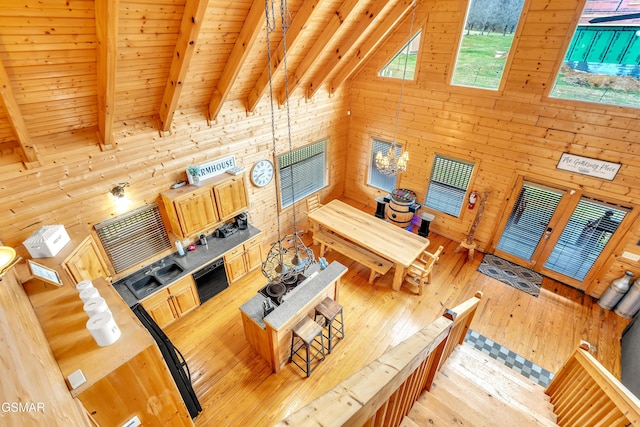 living room with beamed ceiling, high vaulted ceiling, hardwood / wood-style floors, wooden walls, and wood ceiling