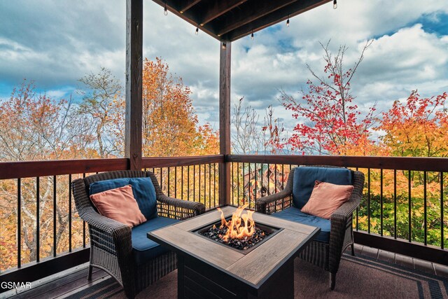 wooden terrace with a fire pit