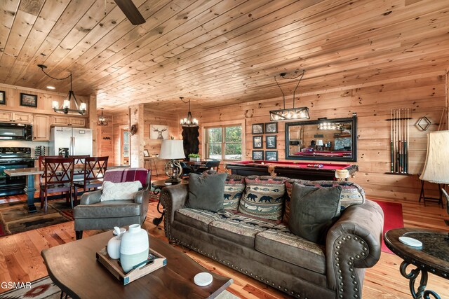 living room with wood walls, wood ceiling, billiards, and light hardwood / wood-style flooring