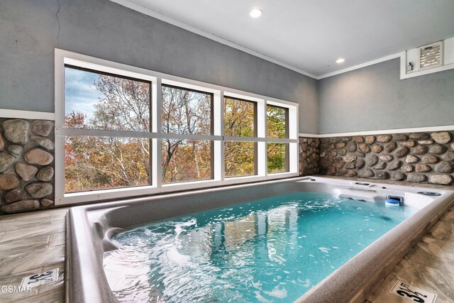 view of swimming pool with an indoor hot tub