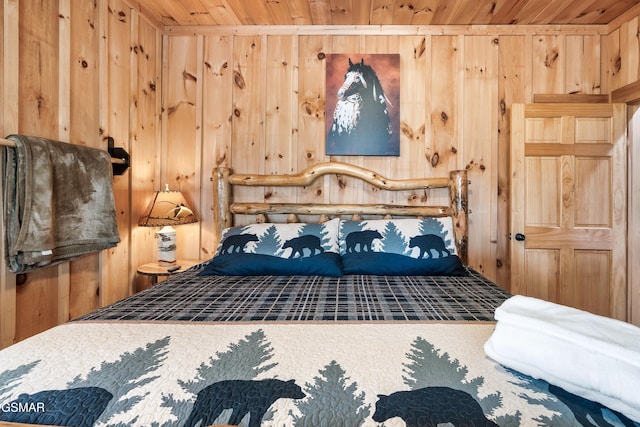 bedroom with wood walls and wooden ceiling