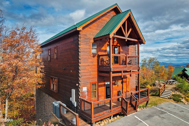 back of house featuring a balcony and cooling unit