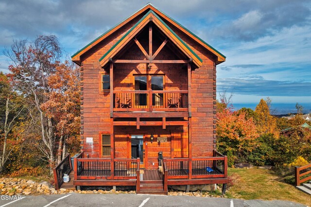 log home featuring a balcony