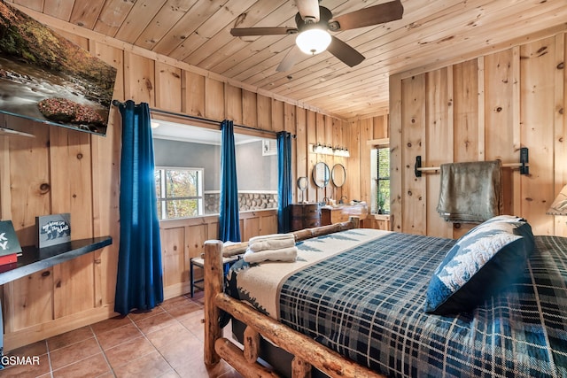 bedroom with tile patterned floors, wooden walls, ceiling fan, and wooden ceiling