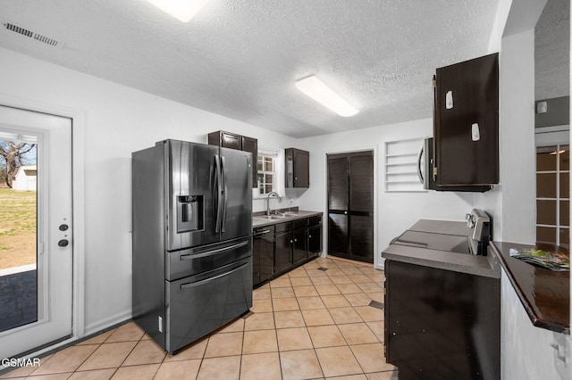 kitchen with a sink, visible vents, refrigerator with ice dispenser, dishwasher, and stainless steel microwave