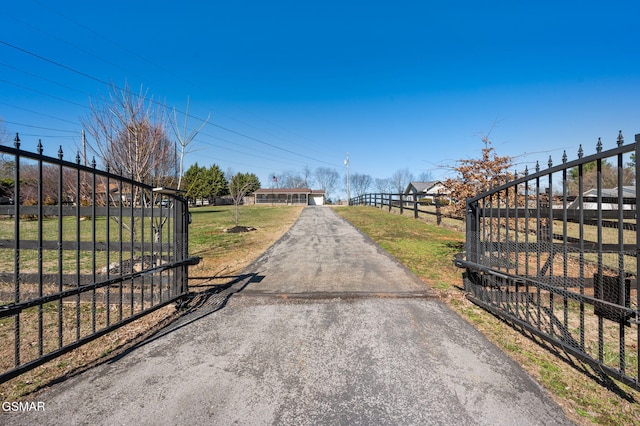 view of road with aphalt driveway and a gated entry