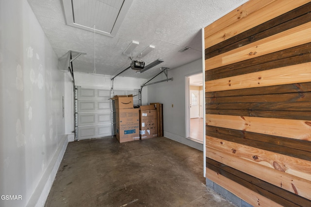 garage with baseboards and a garage door opener