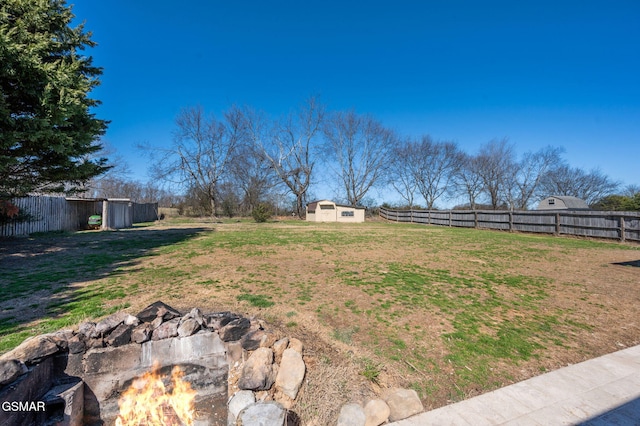 view of yard with an outbuilding, fence, and a storage unit