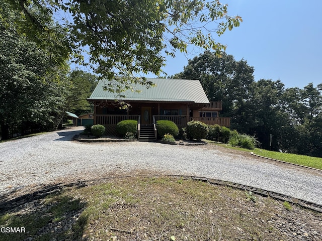 2452 Skyview Way, Dandridge, TN 37725 - rustic home featuring a porch, curved driveway, and metal roof