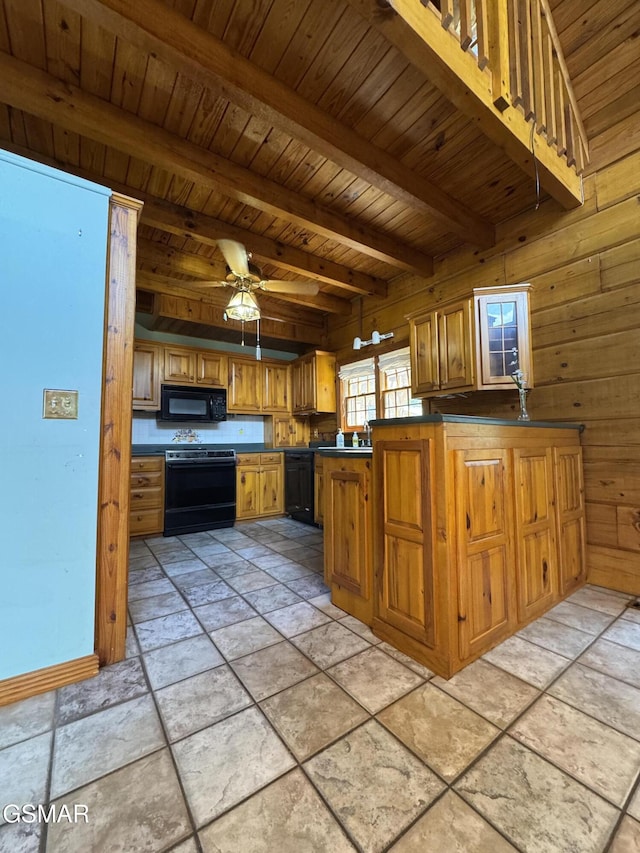 2452 Skyview Way, Dandridge, TN 37725 - kitchen with black appliances, wood walls, stone tile floors, brown cabinets, and wooden ceiling with exposed beams